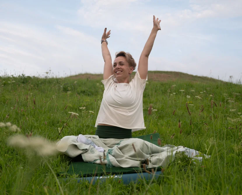 Person practicing morning wellness routine in peaceful setting